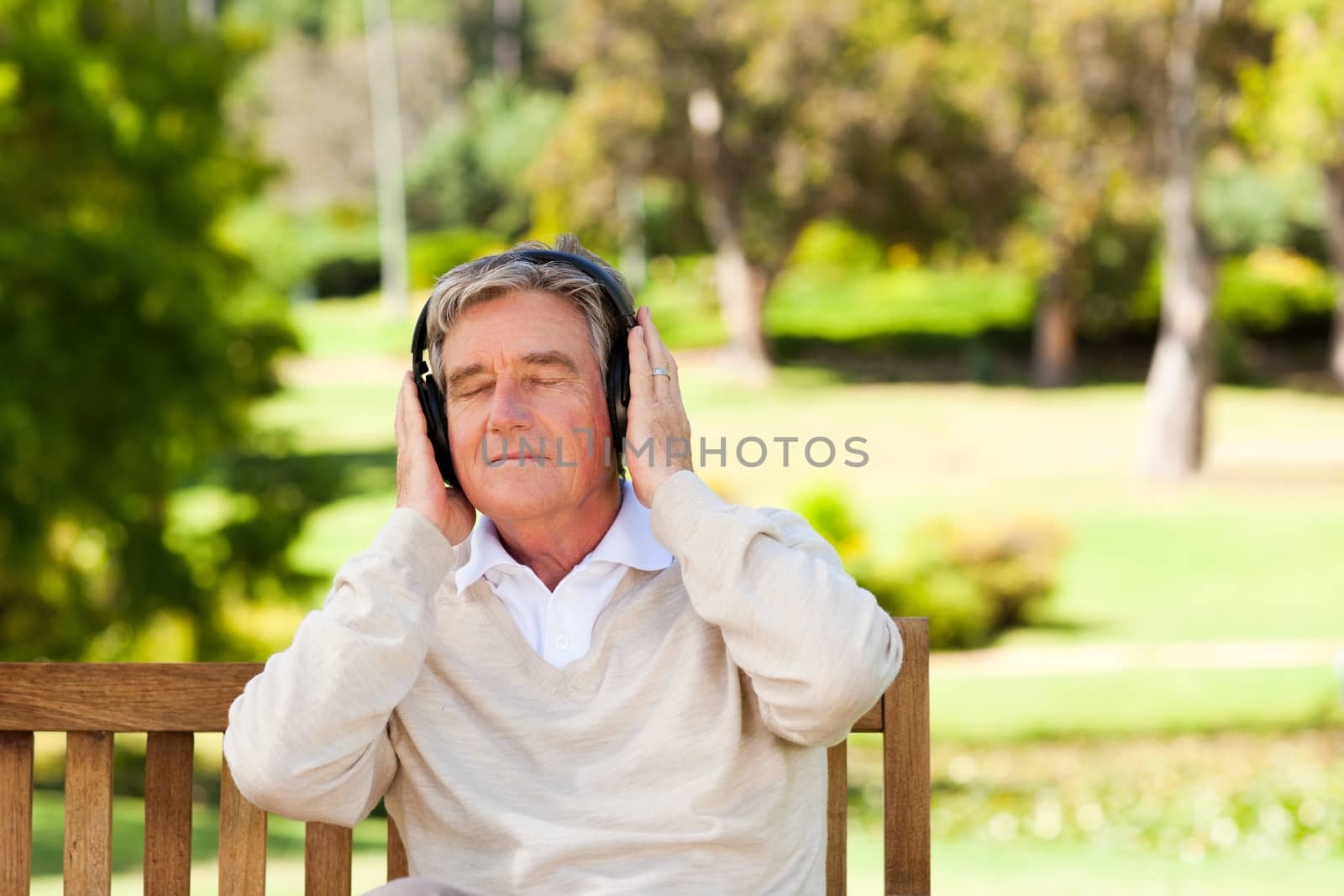 Retired man listening to some music during the summer