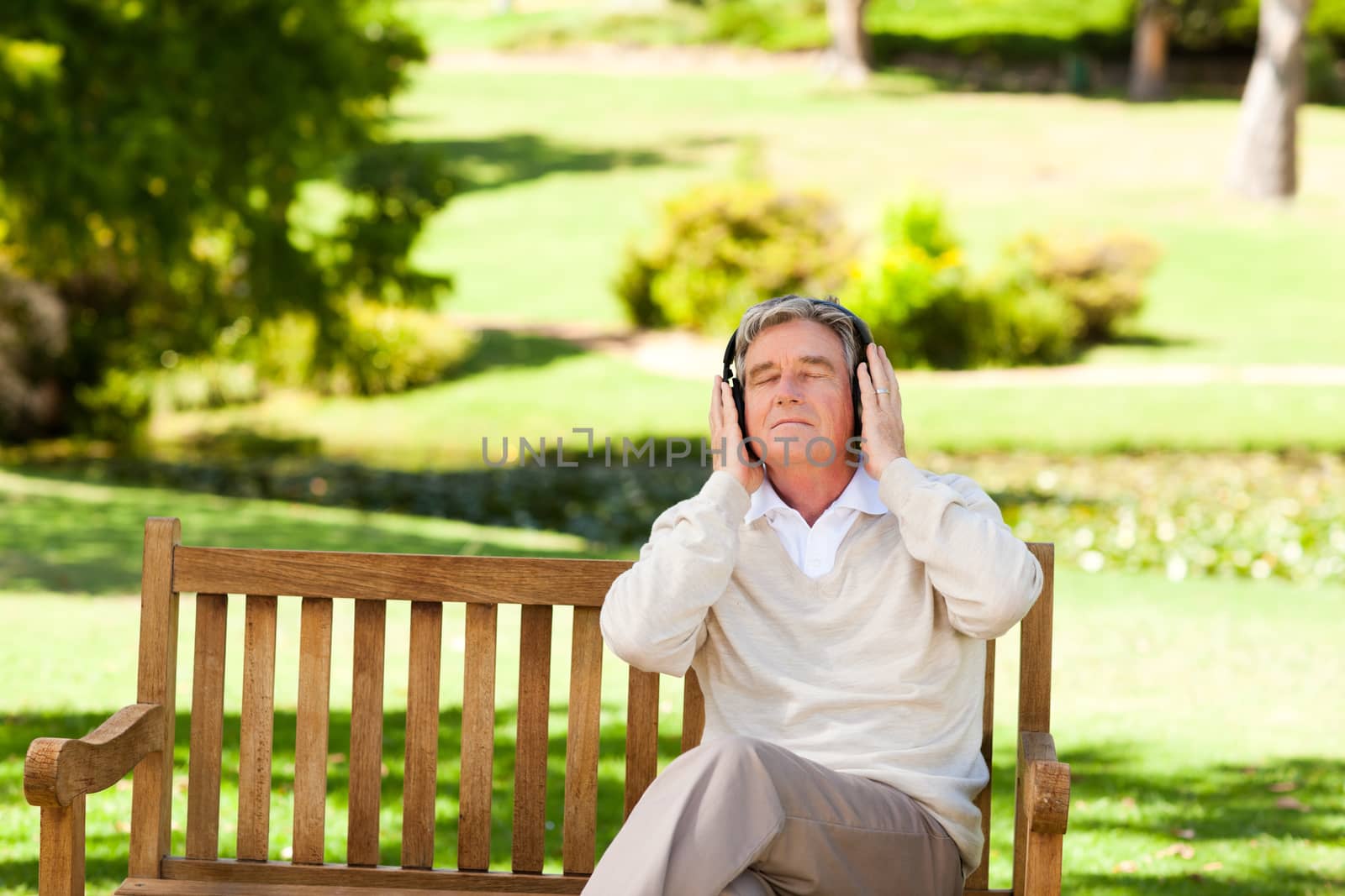 Retired man listening to some music during the summer