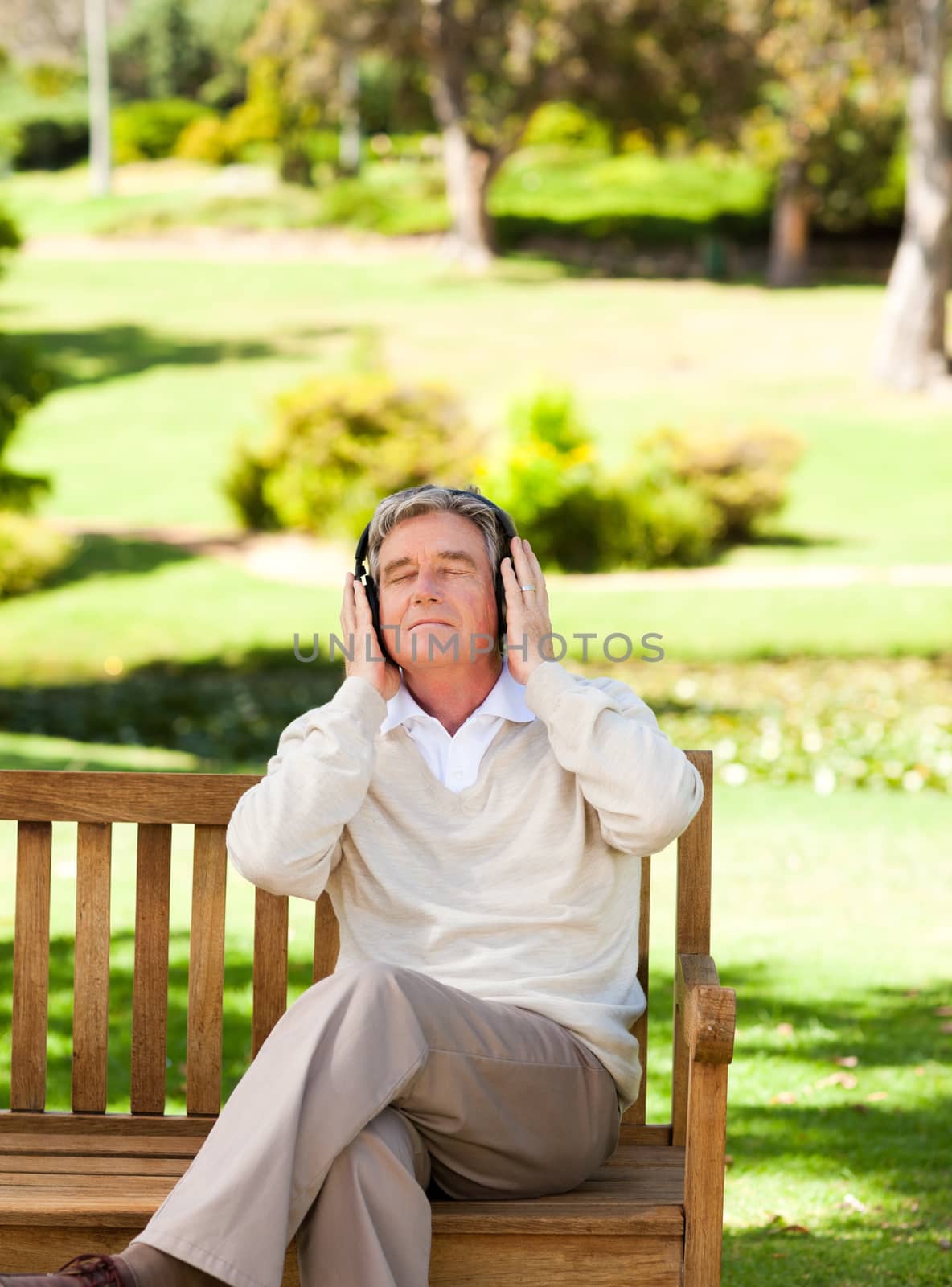 Retired man listening to some music by Wavebreakmedia