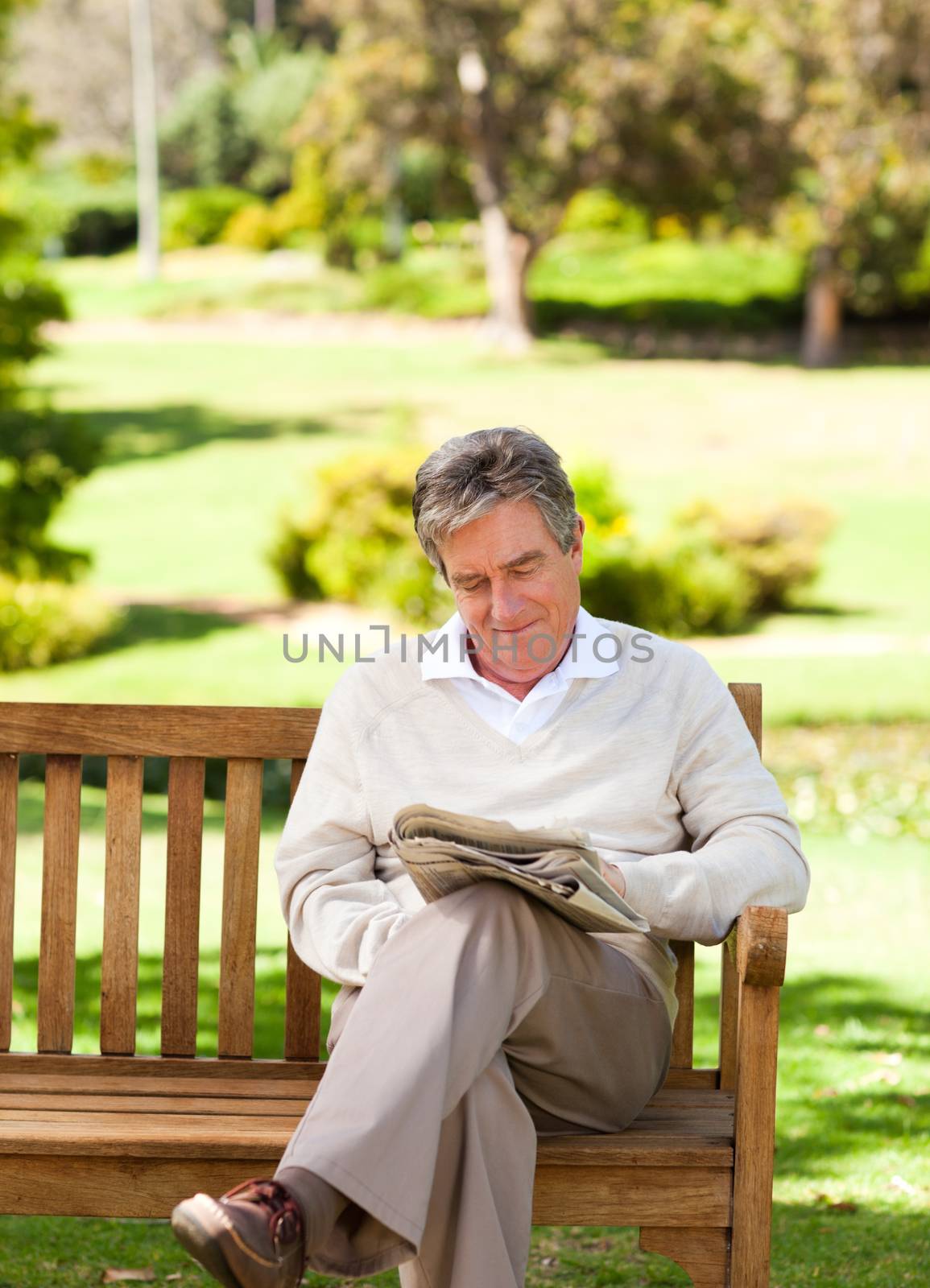 Man reading a newspaper during the summer