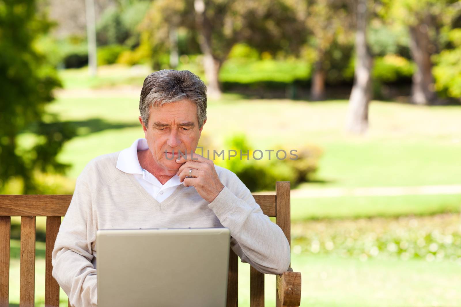 Senior man working on his laptop by Wavebreakmedia