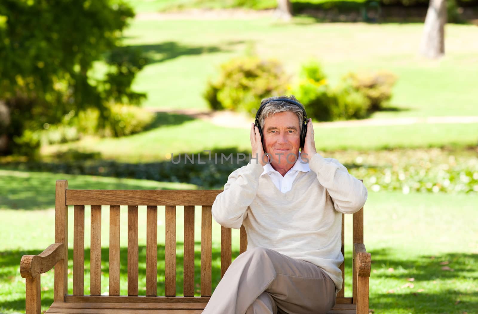 Retired man listening to some music by Wavebreakmedia