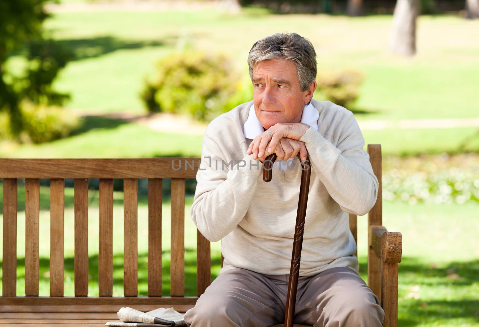 Elderly man with his walking stick during the summer