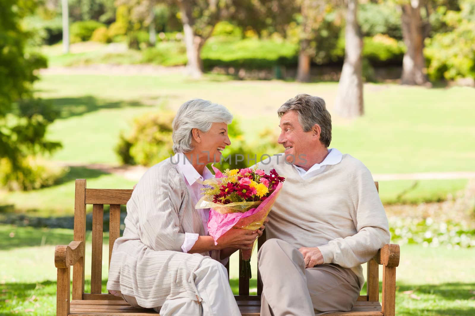 Senior man offering flowers to his wife by Wavebreakmedia