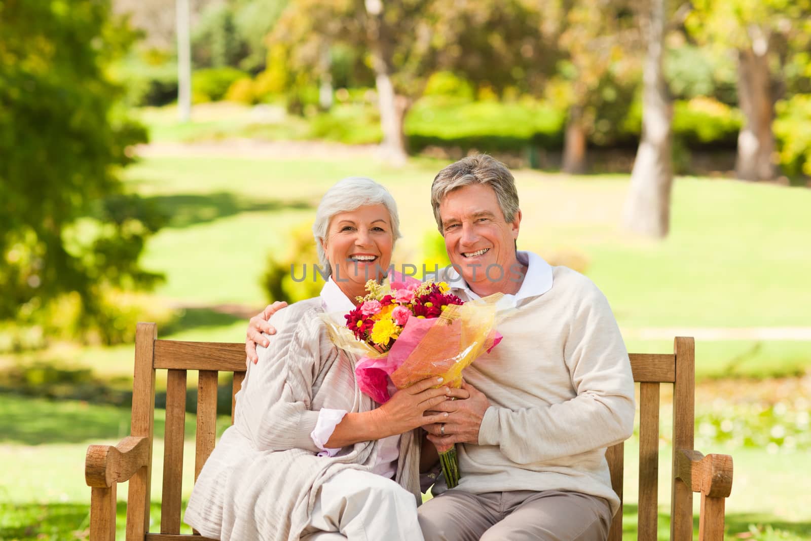 Senior man offering flowers to his wife by Wavebreakmedia