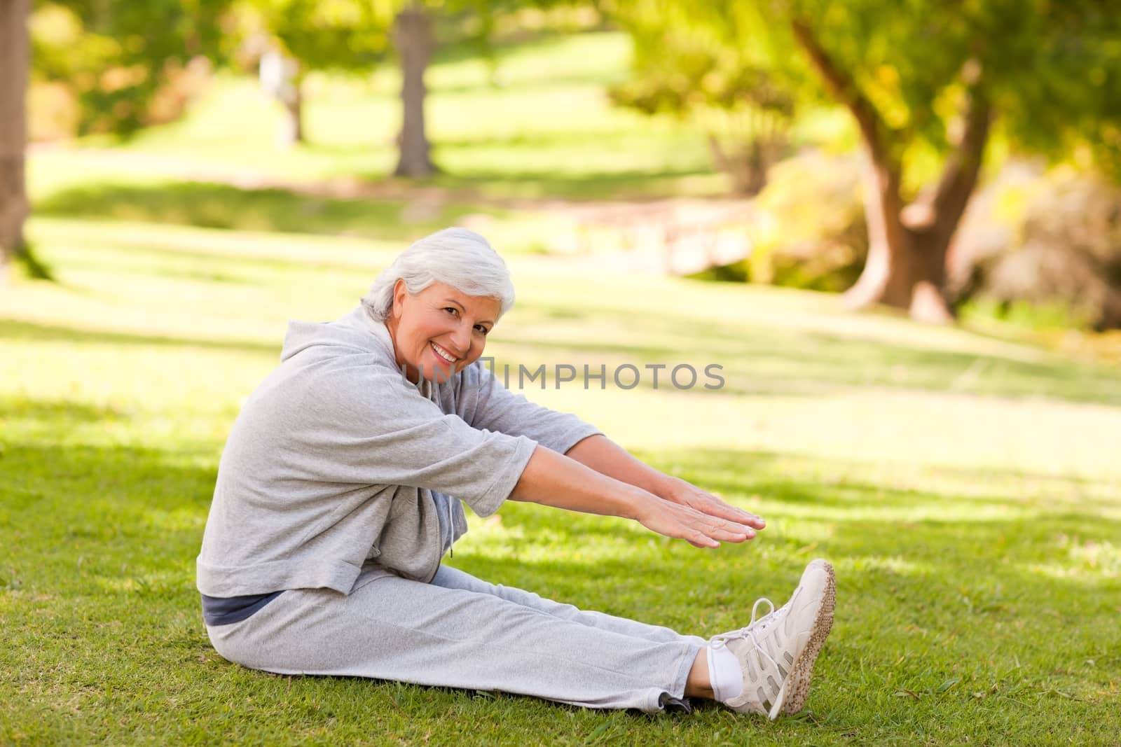 Retired woman doing her stretches in the park by Wavebreakmedia