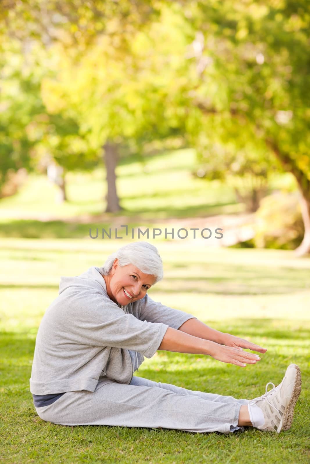 Retired woman doing her stretches in the park by Wavebreakmedia