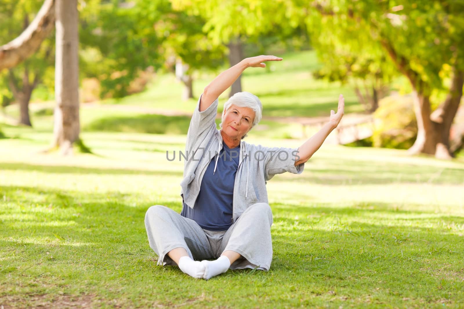 Senior woman doing her stretches in the park by Wavebreakmedia