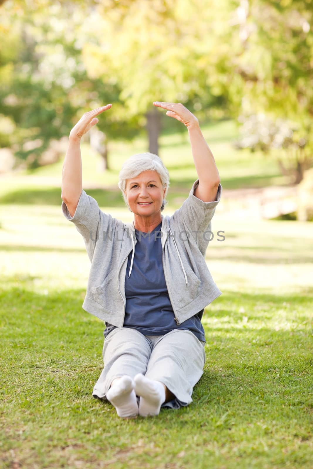 Senior woman doing her stretches in the park by Wavebreakmedia