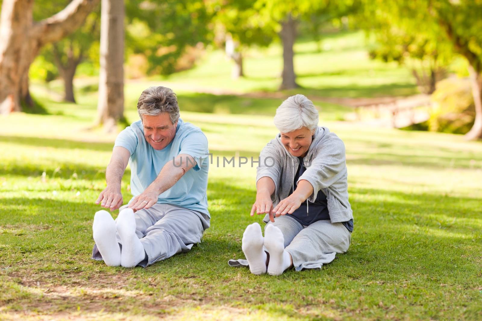 Elderly couple doing their stretches in the park by Wavebreakmedia