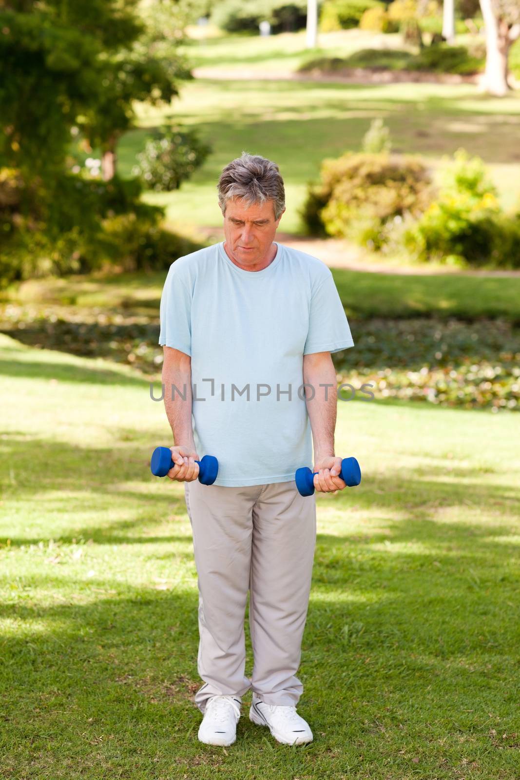 Mature man doing his exercises in the park by Wavebreakmedia