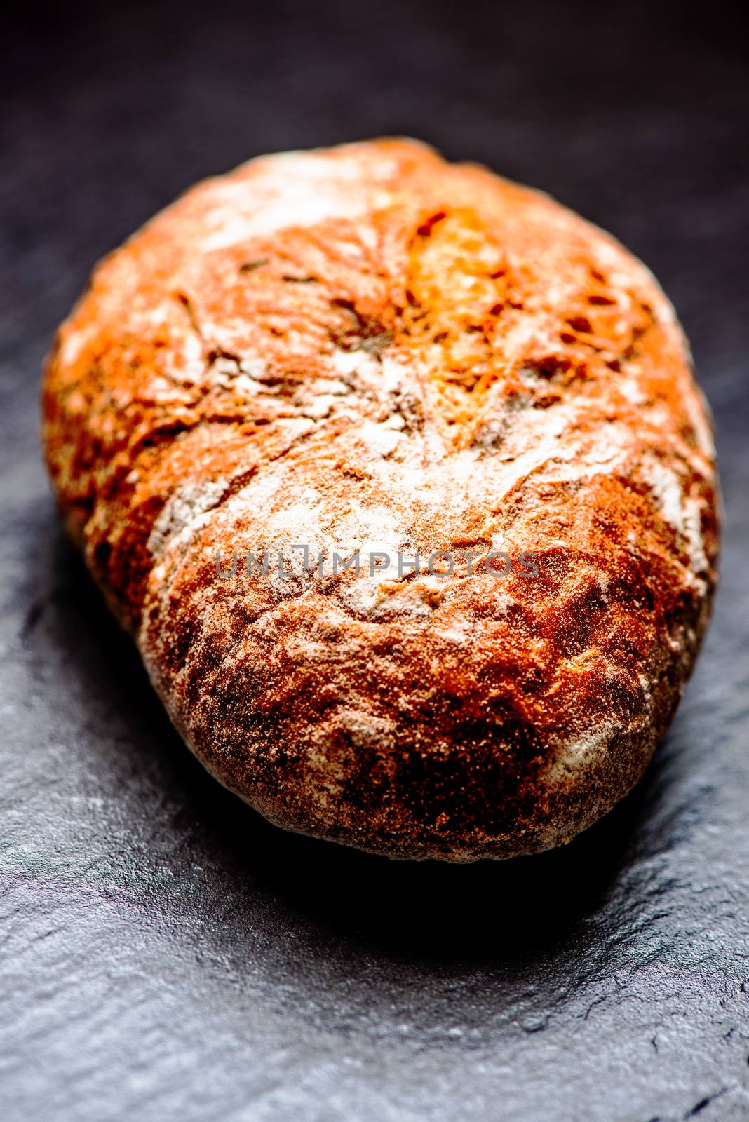 Bread loaf on stone surface