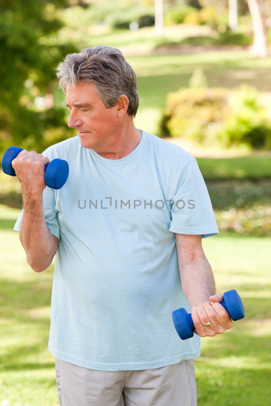 Elderly man doing his exercises in the park by Wavebreakmedia