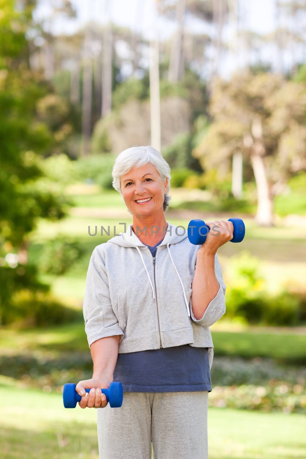 Mature woman doing her exercises in the park by Wavebreakmedia