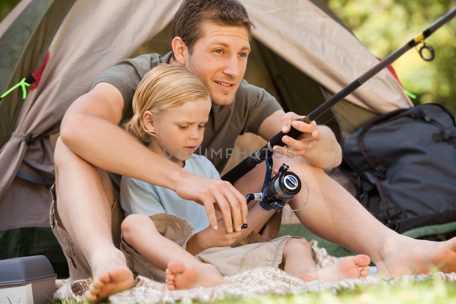 Father fishing with his son during the summer