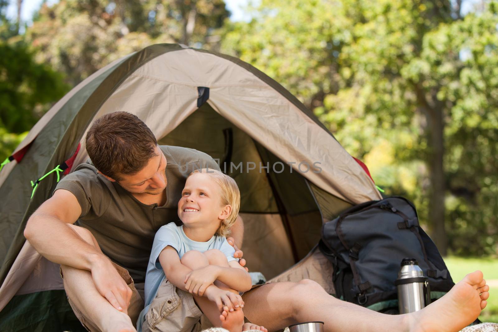 Father and his son camping during the summer