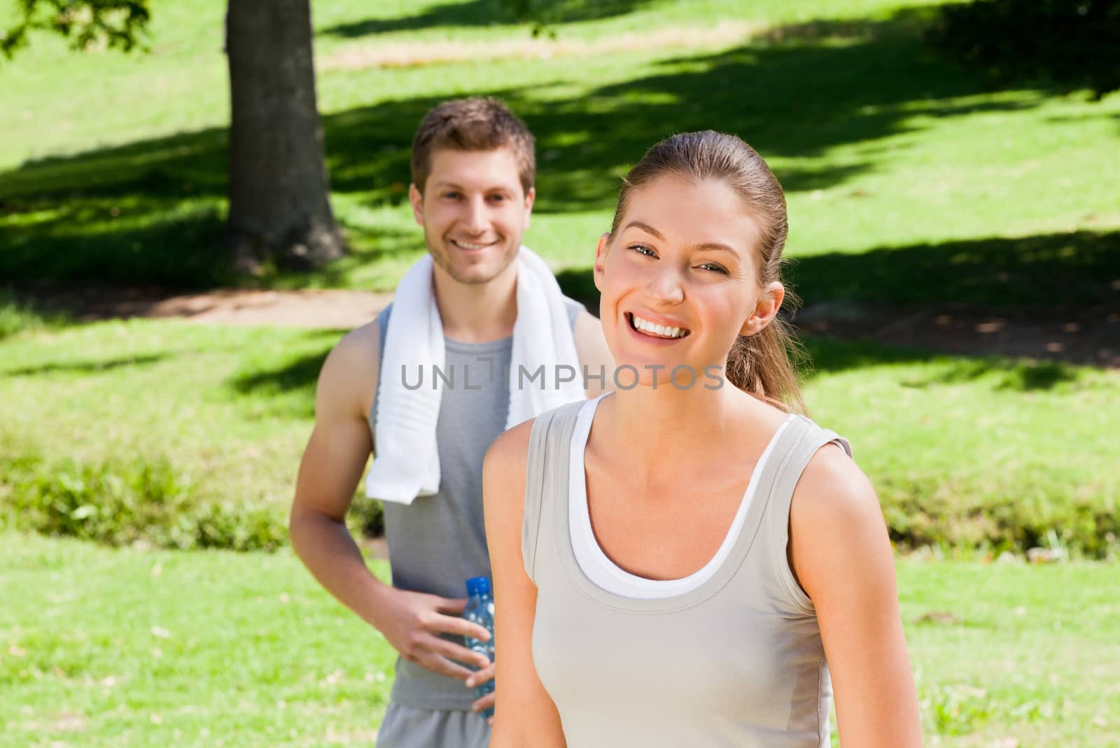 Sporty couple in the park during the summer