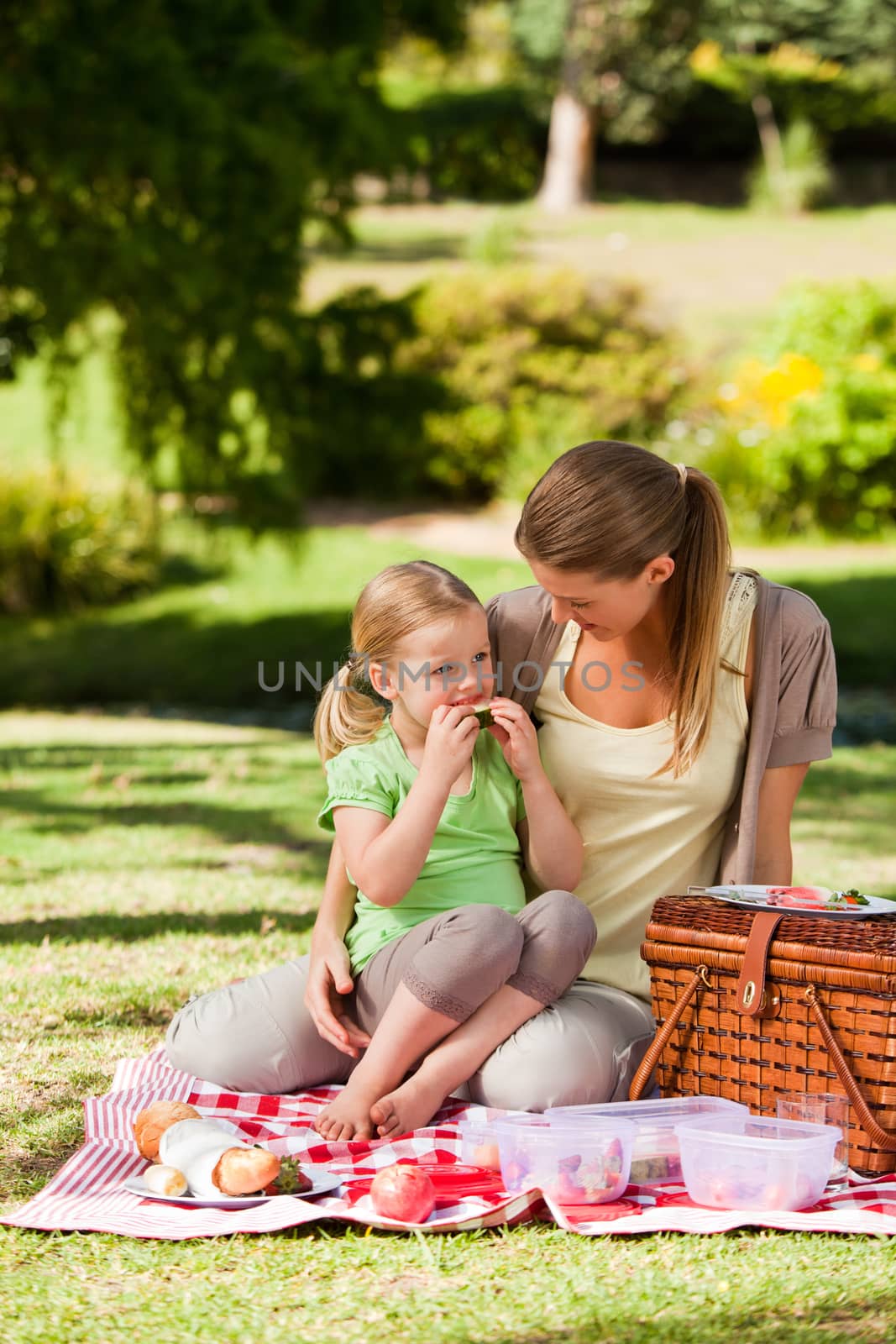 Mother and her daughter picnicking in the park by Wavebreakmedia