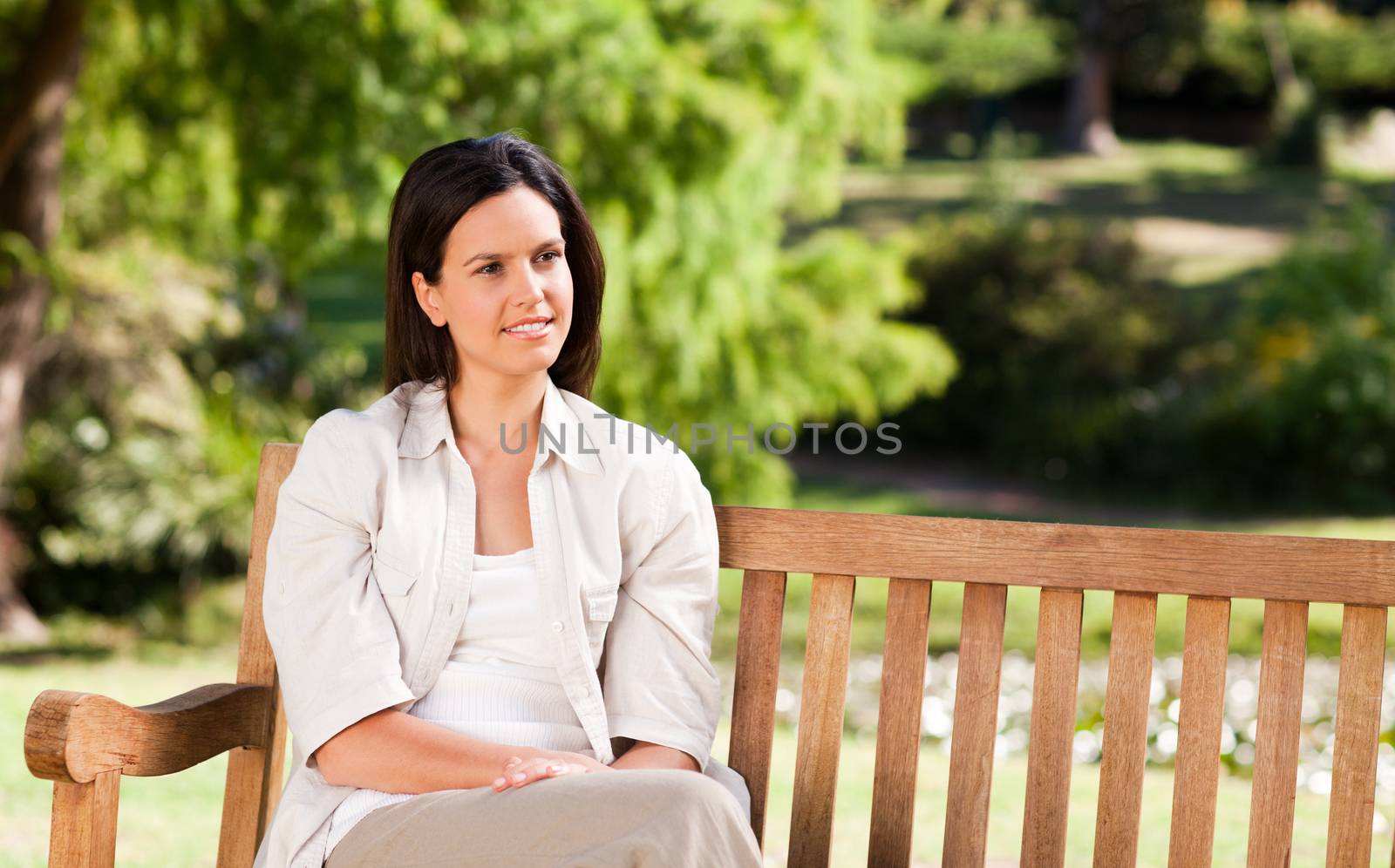 Young woman on the bench during the summer