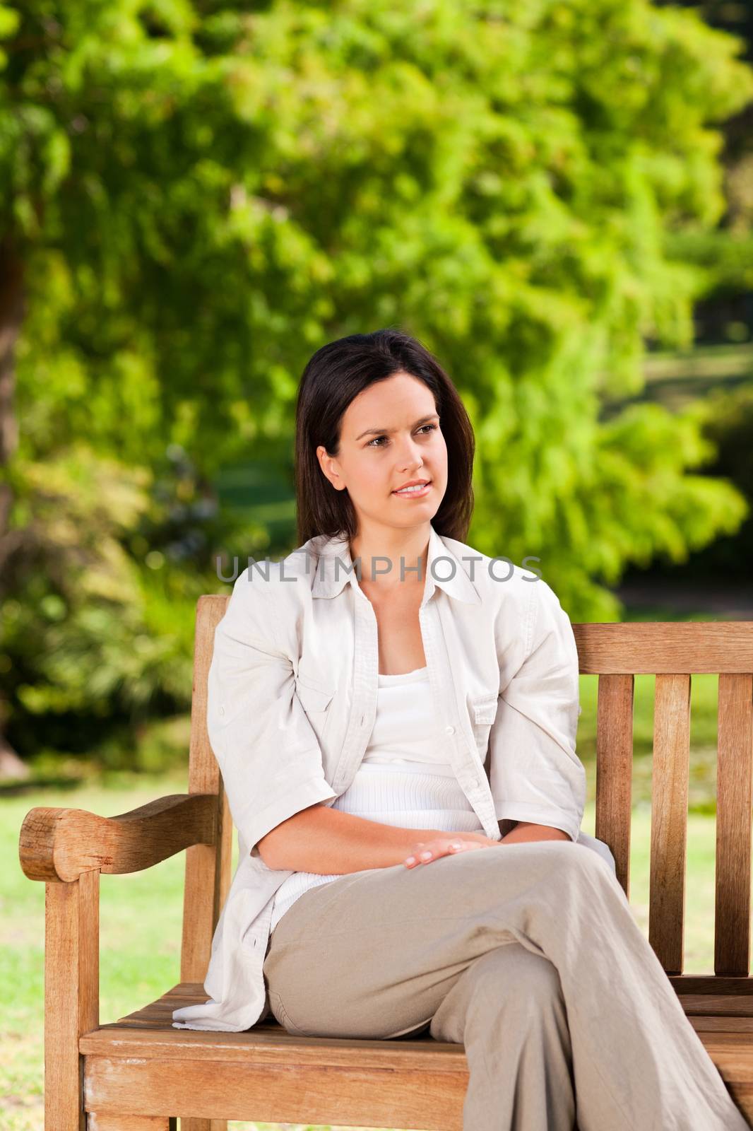 Young woman on the bench during the summer