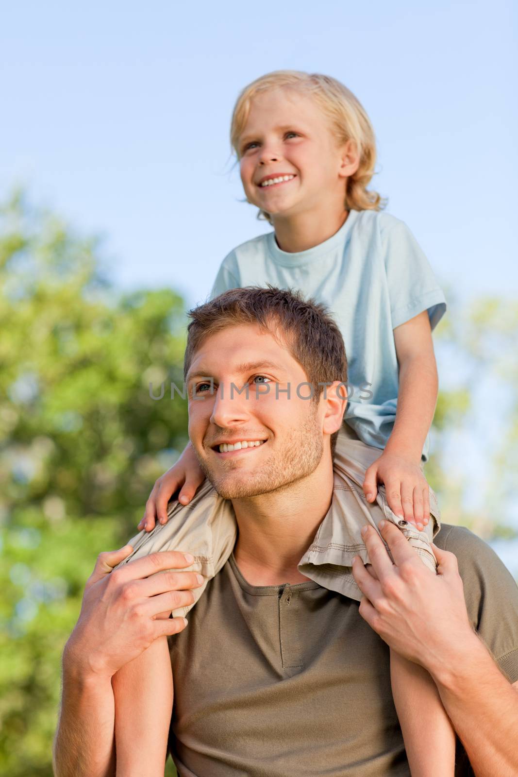 Father giving son a piggyback by Wavebreakmedia