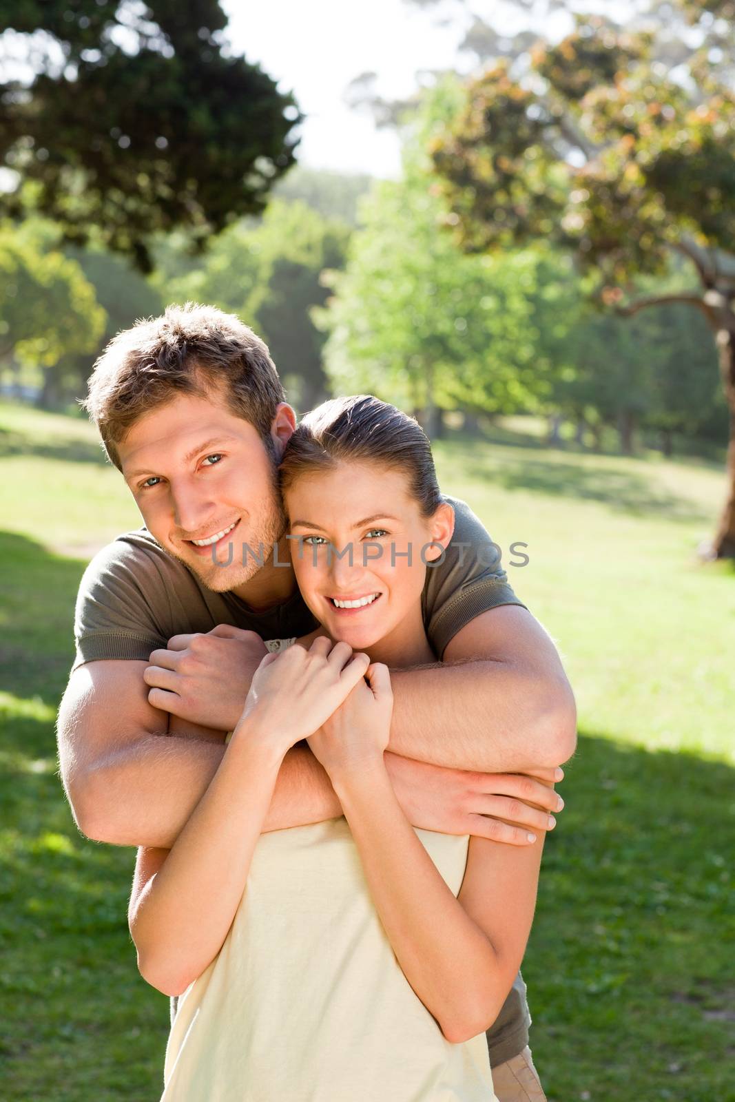 Man hugging his beautiful wife during the summer