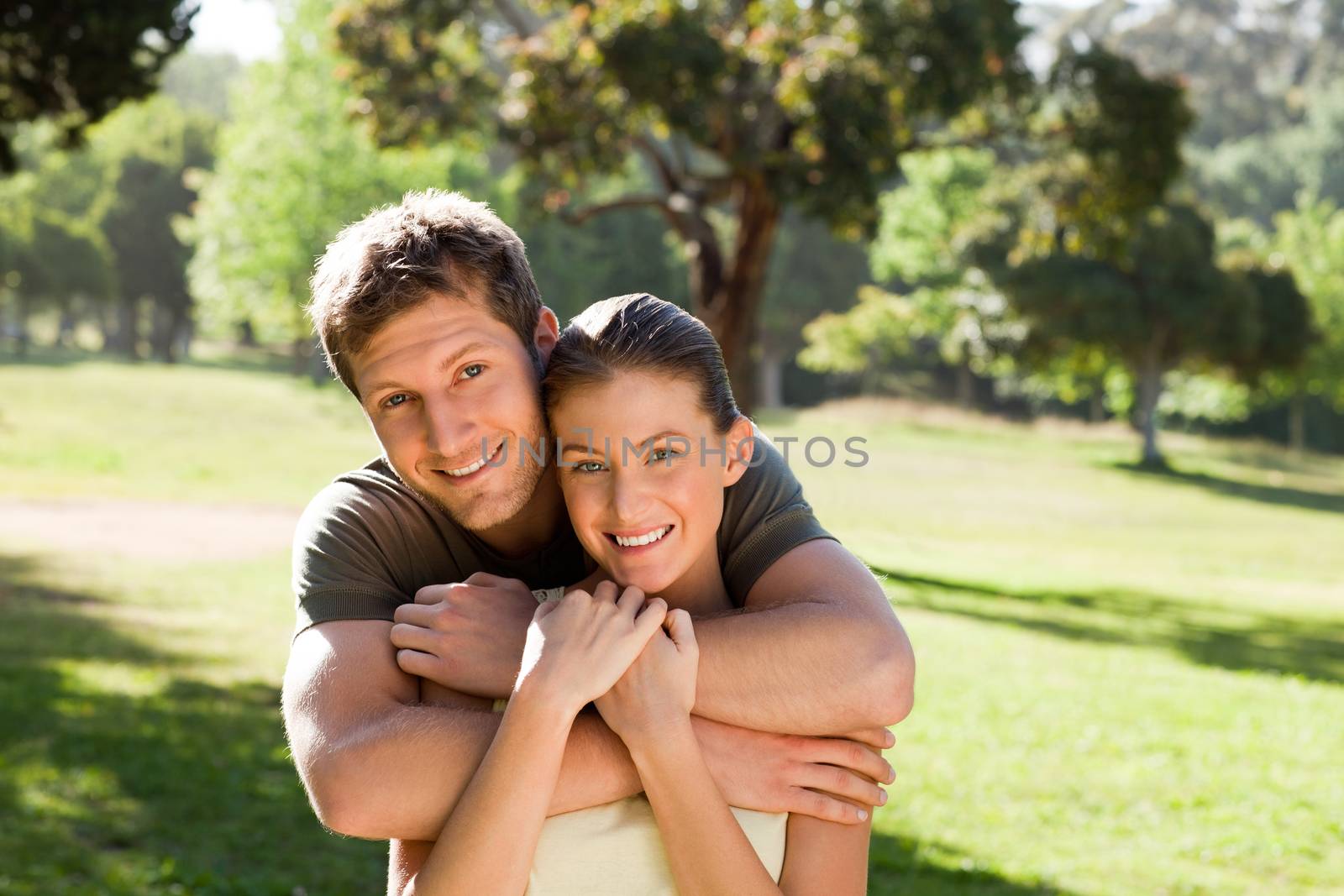 Man hugging his beautiful wife during the summer