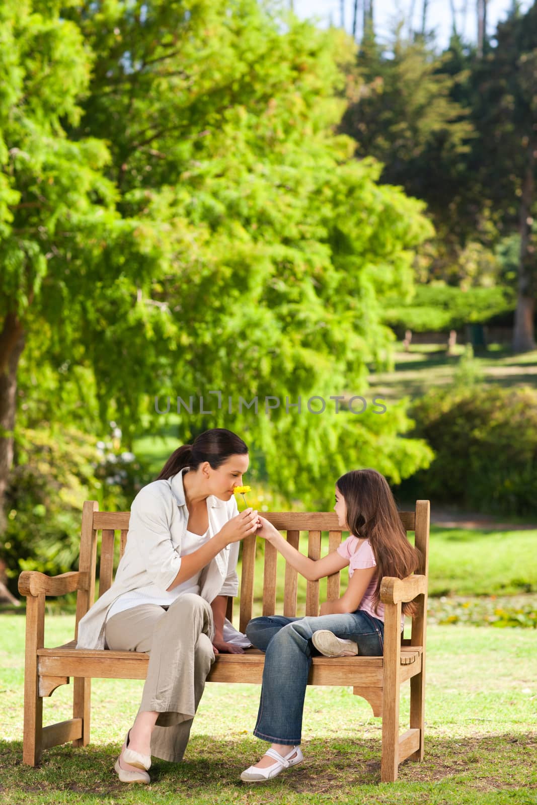 Cute girl with her mother in the park during the summer