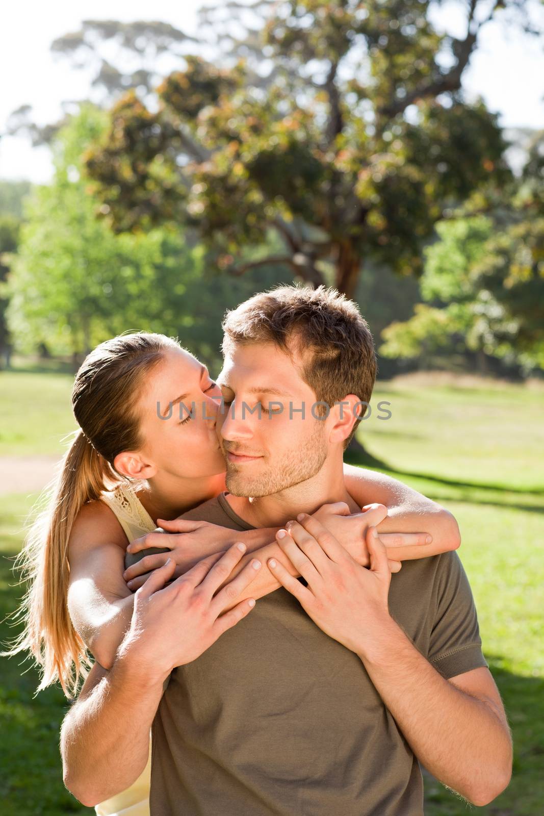 Woman hugging her handsome husband during the summer