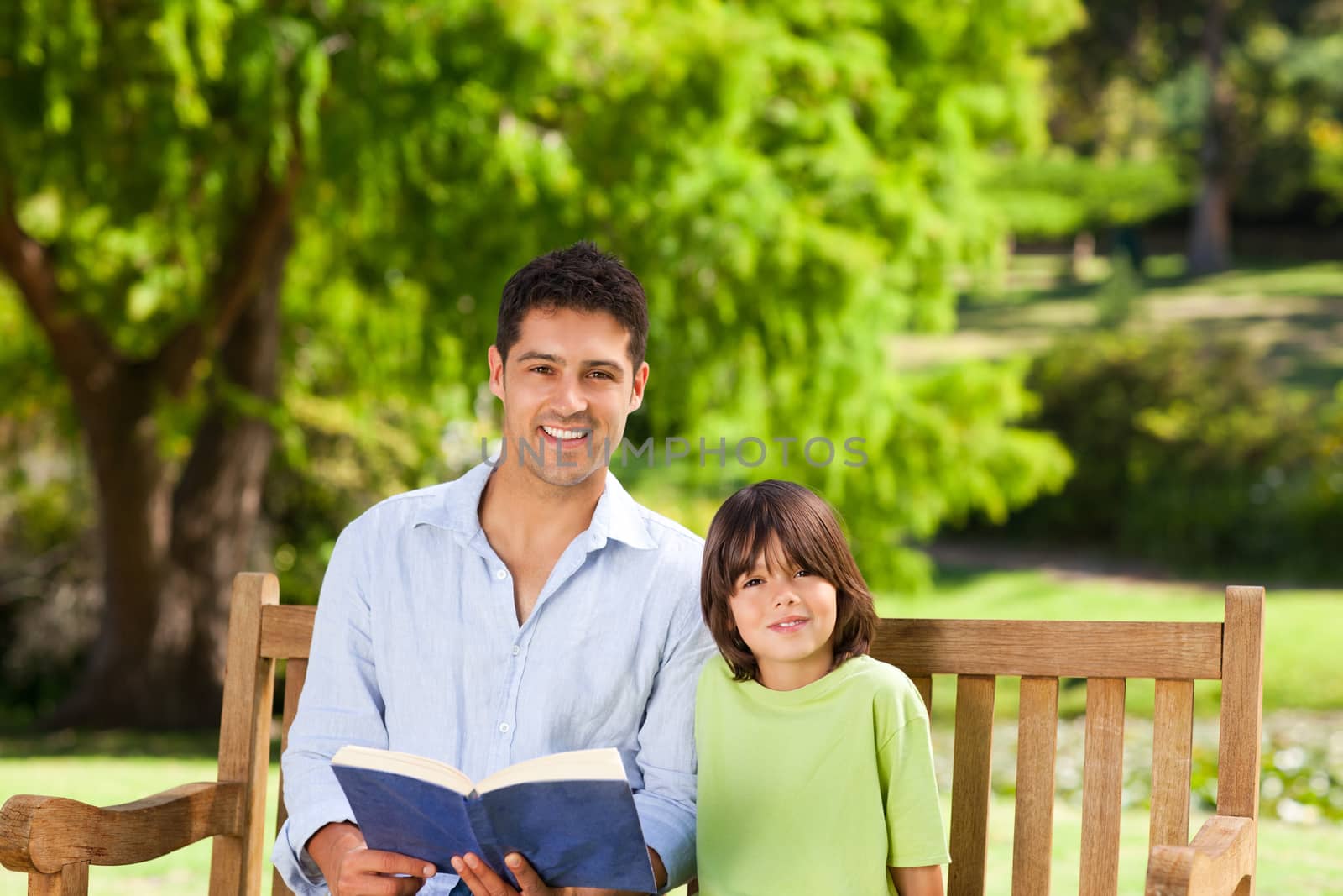 Son with his father reading a book by Wavebreakmedia