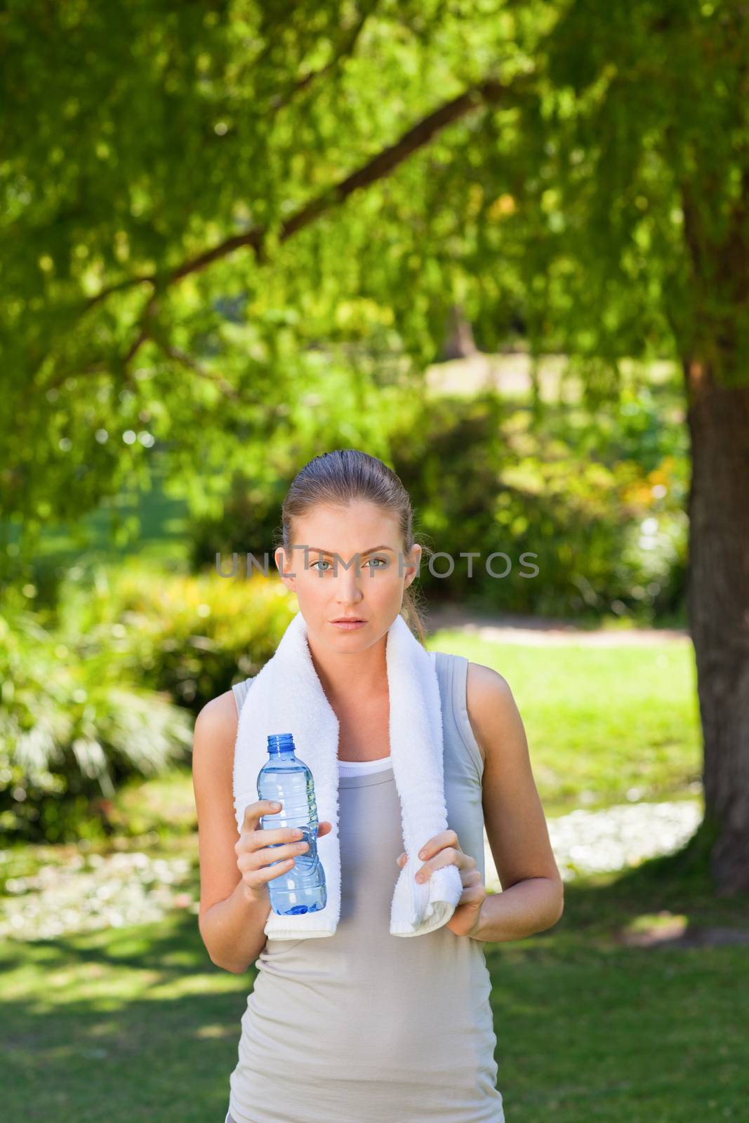 Woman drinking water after the gym during the summer