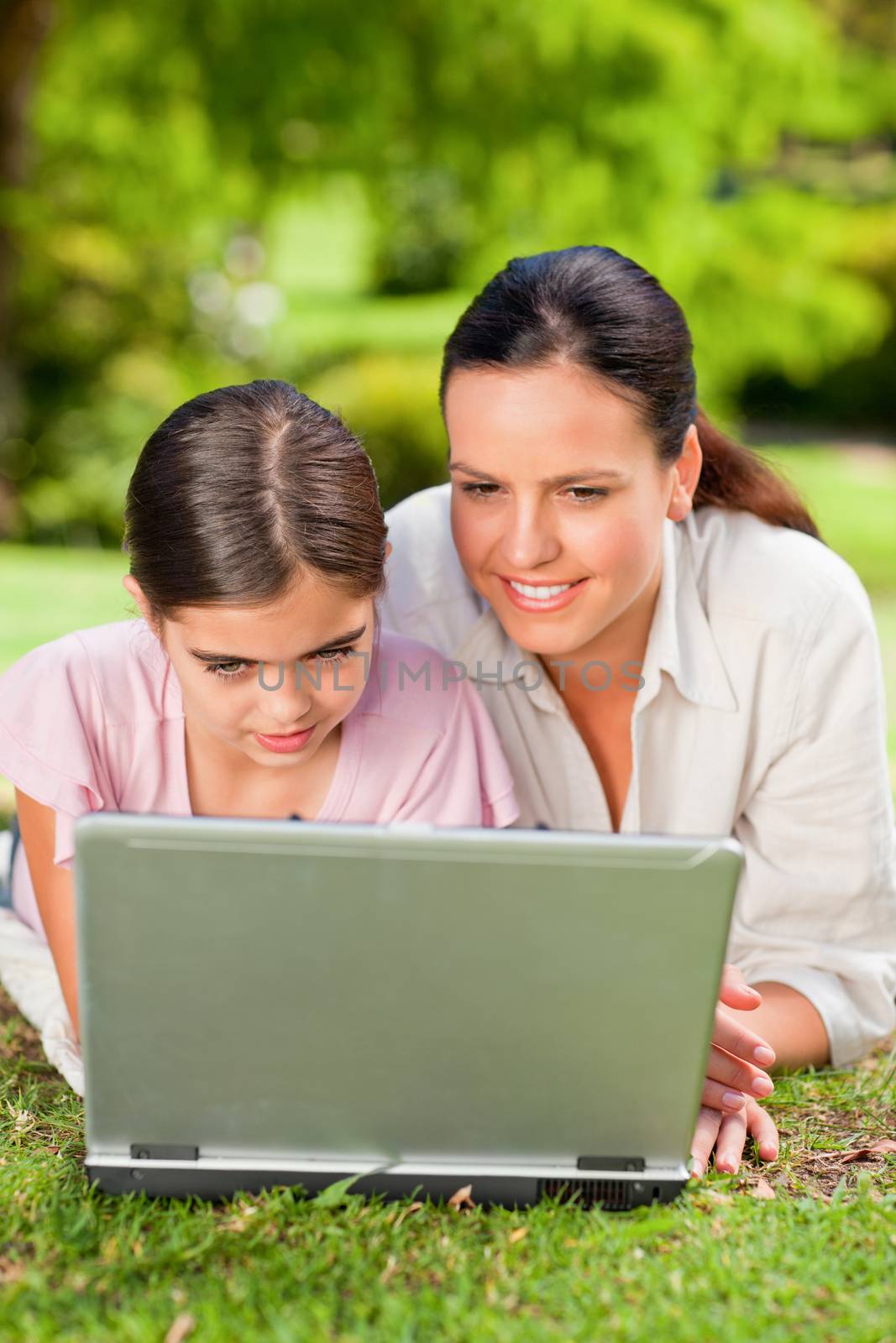 Mother and her daughter looking at their laptop by Wavebreakmedia