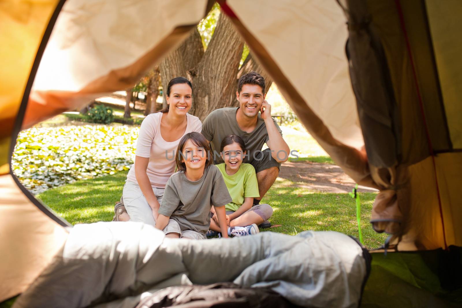 Joyful family camping in the park during the summer