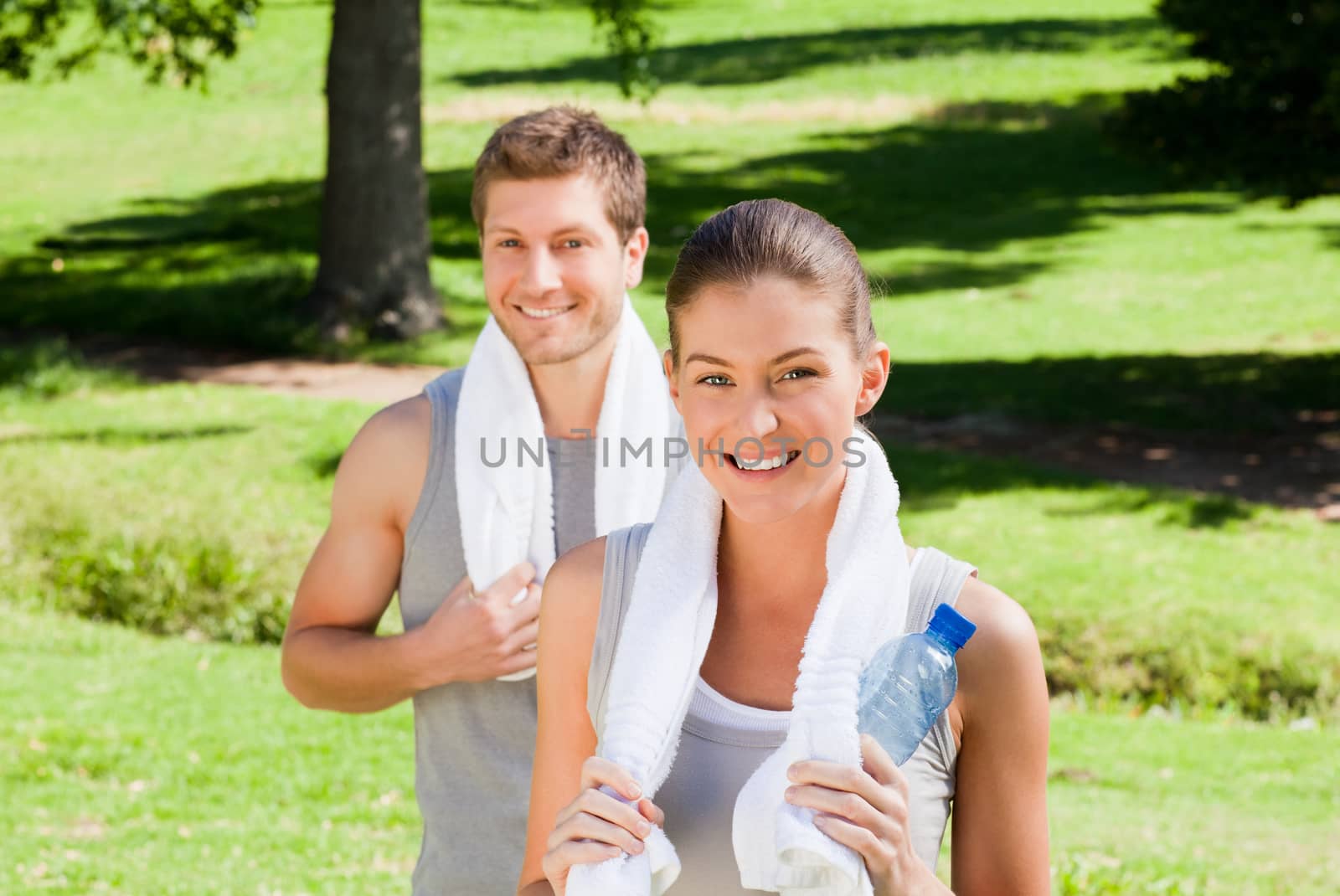 Sporty couple in the park during the summer