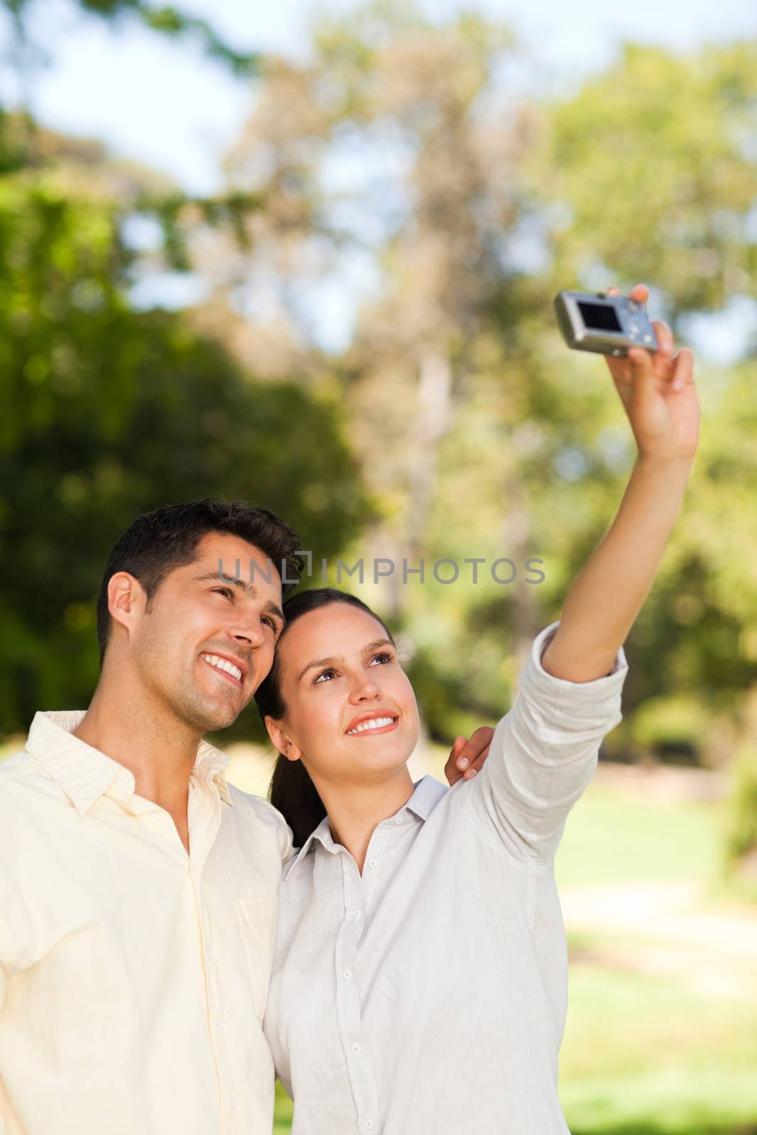 Young couple taking a photo of themselves  by Wavebreakmedia