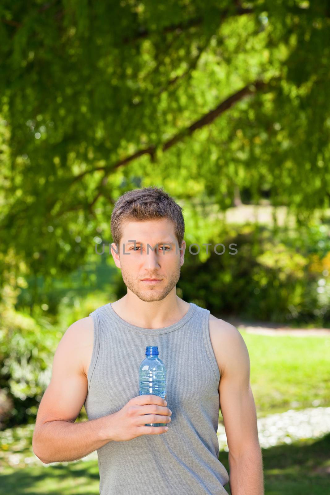 Sporty handsome man in the park during the summer