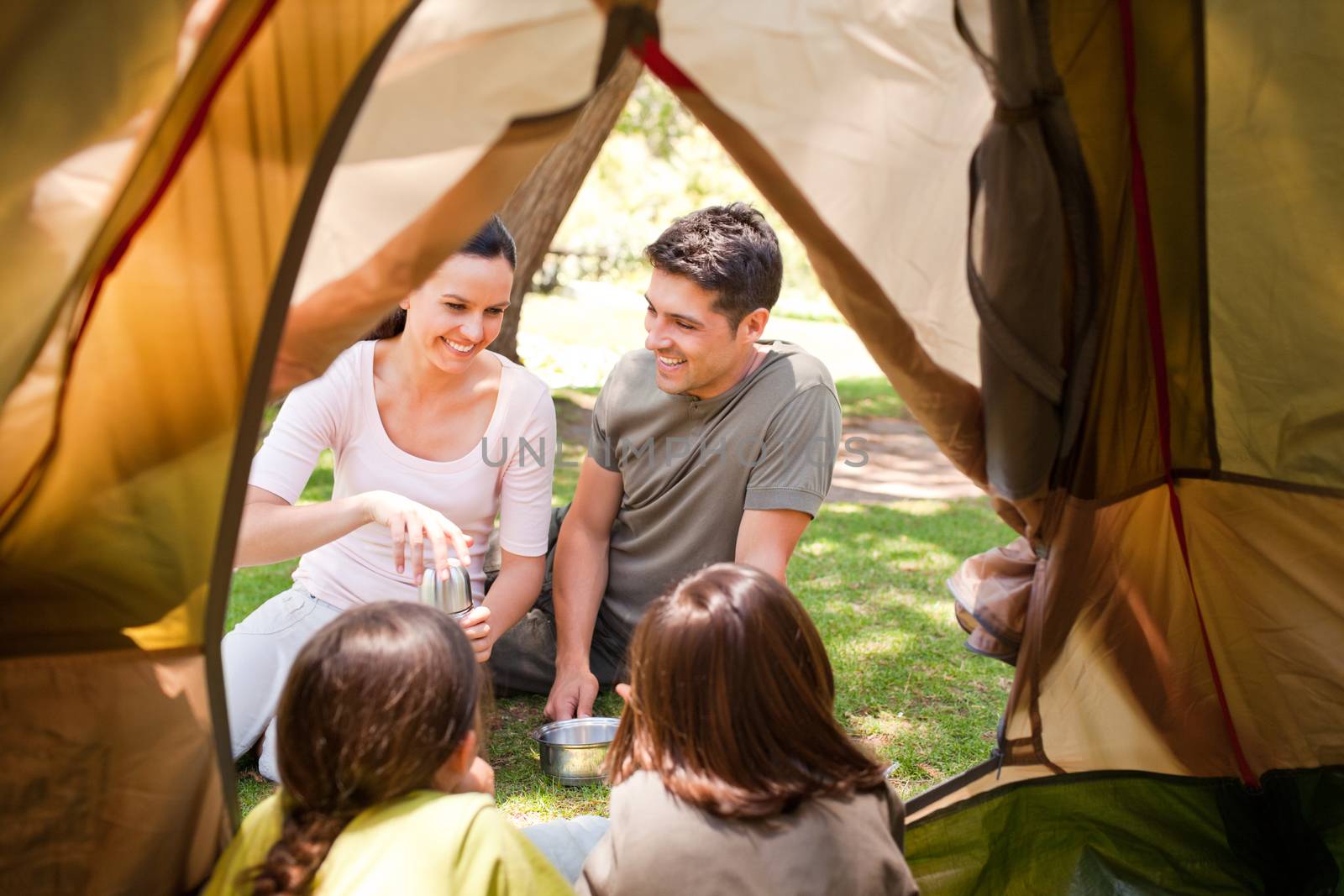 Happy family camping in the park by Wavebreakmedia
