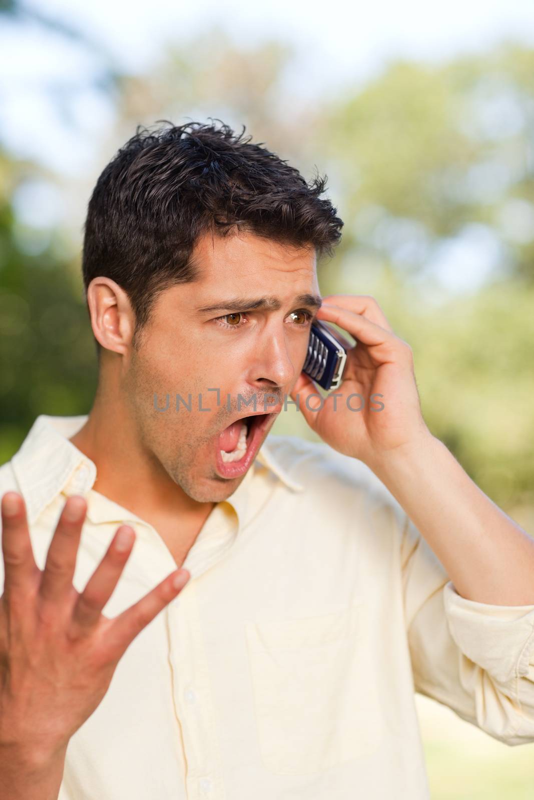 Man phoning in the park during the summer 