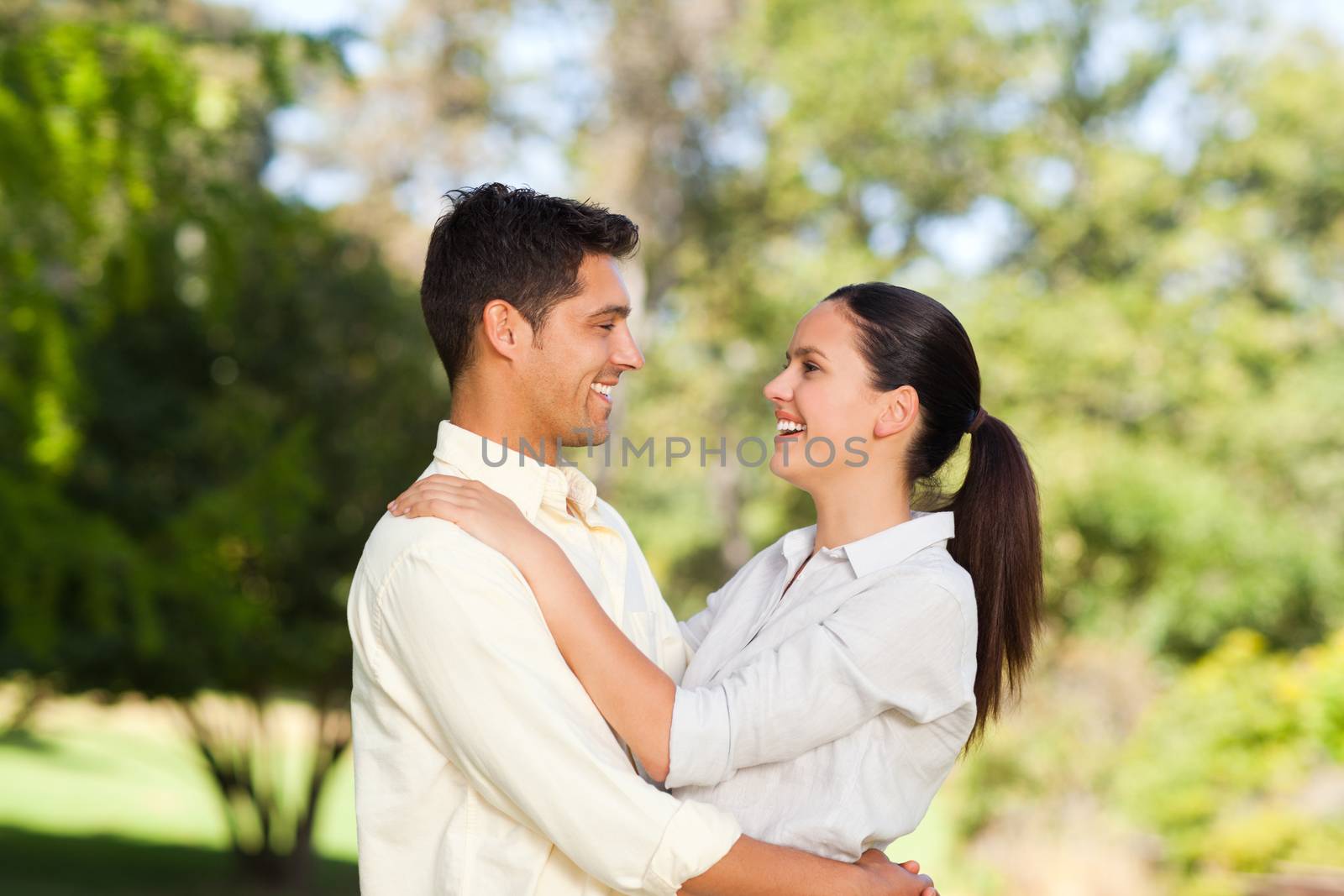 Happy lovers in the park during the summer