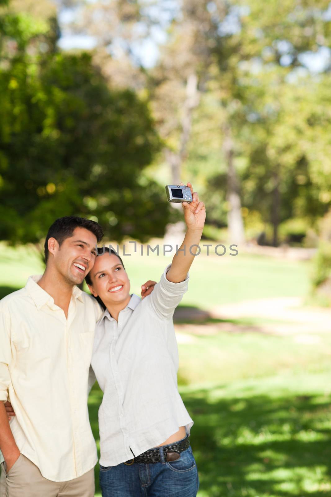 Young couple taking a photo of themselves during the summer 