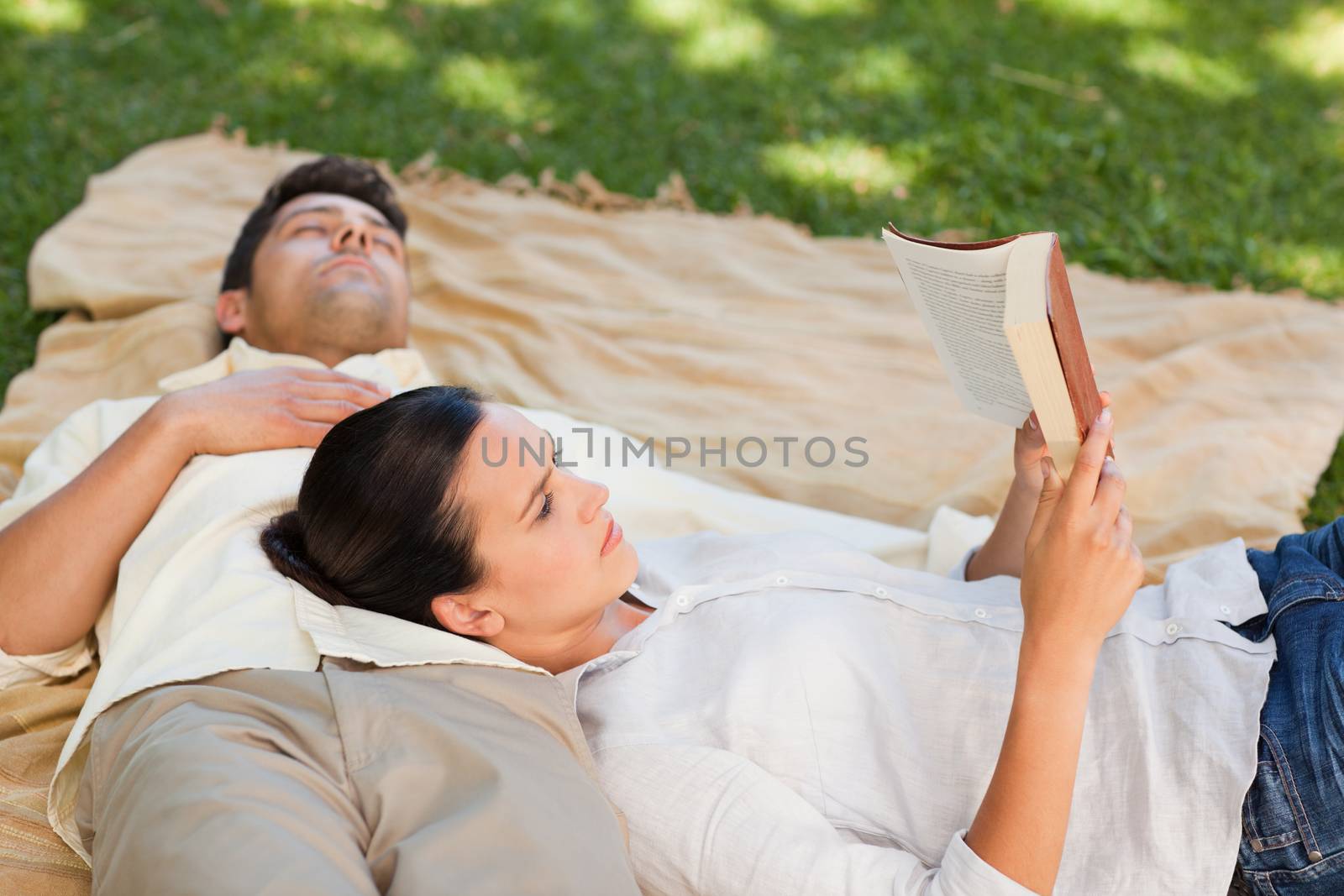 Couple reading in the park during the summer