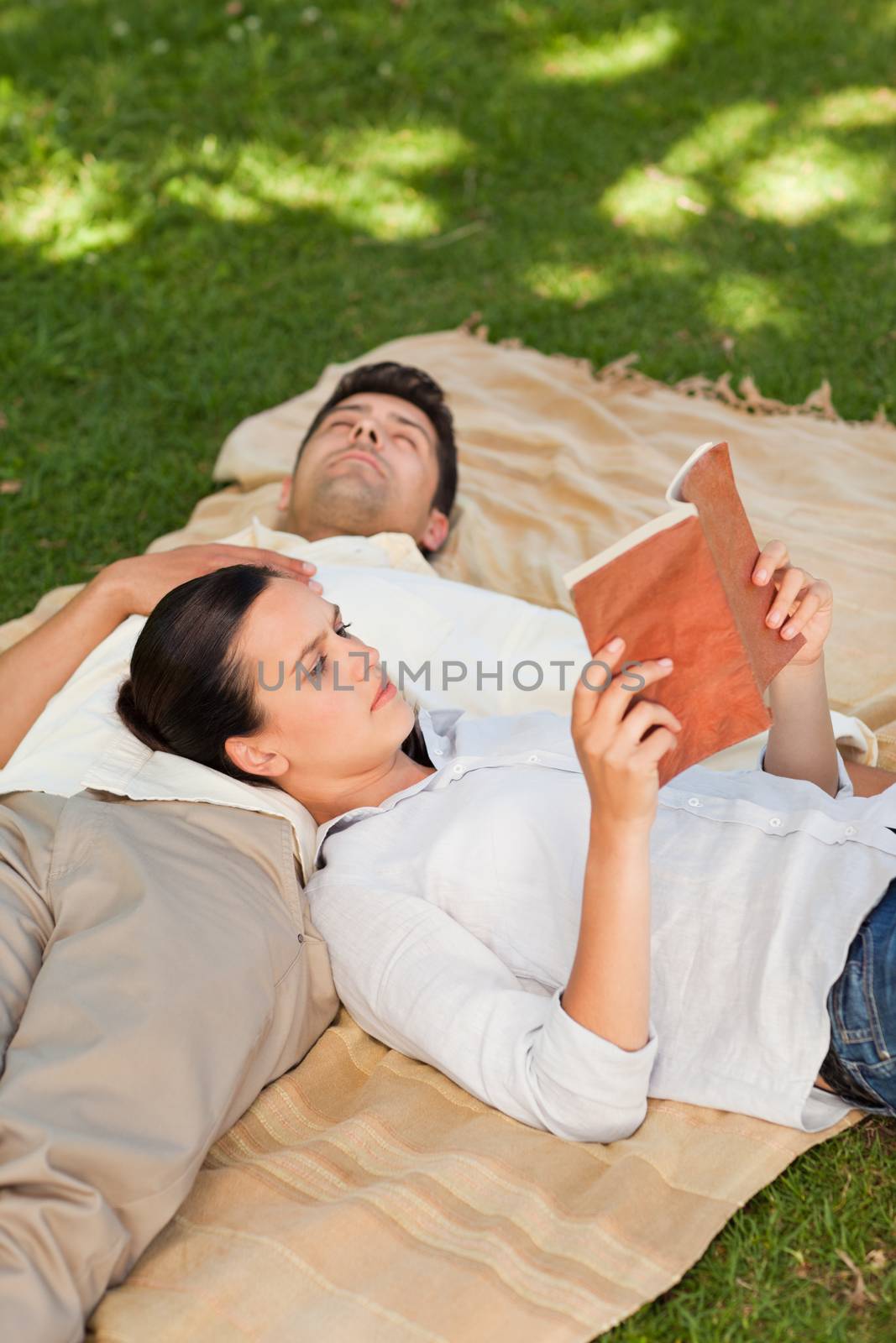 Couple reading in the park during the summer