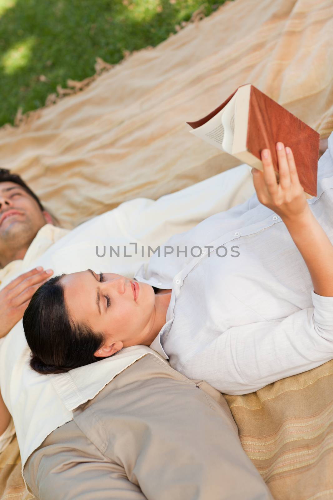 Couple reading in the park during the summer