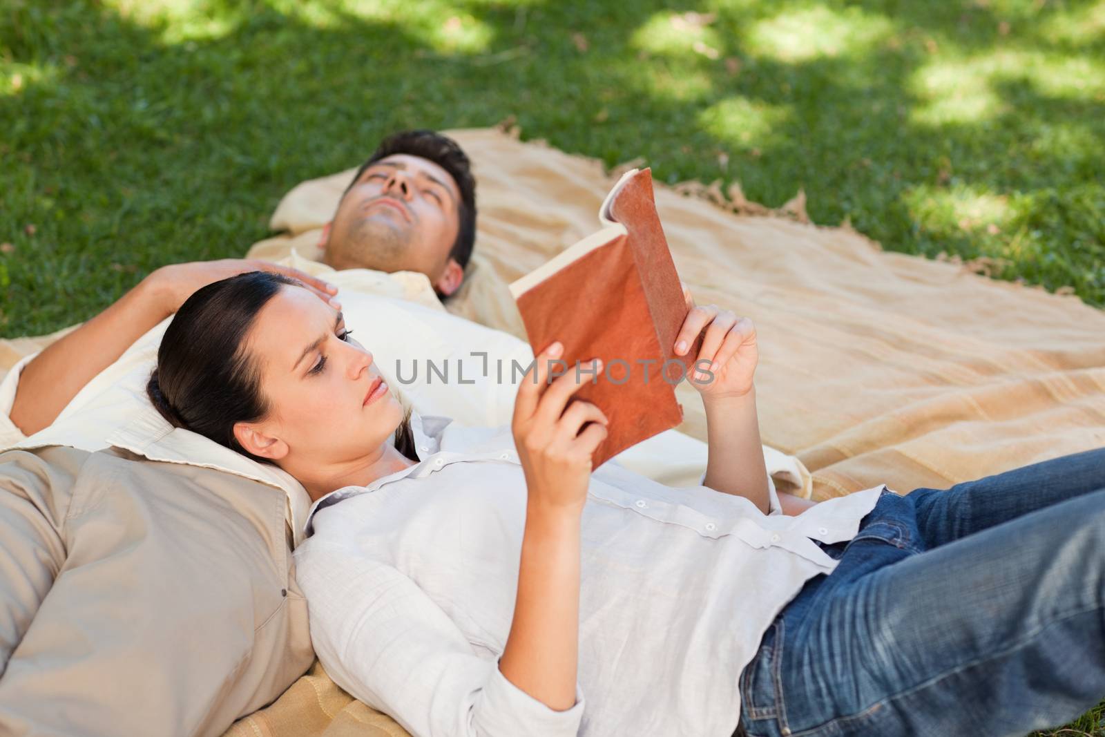 Couple reading in the park during the summer