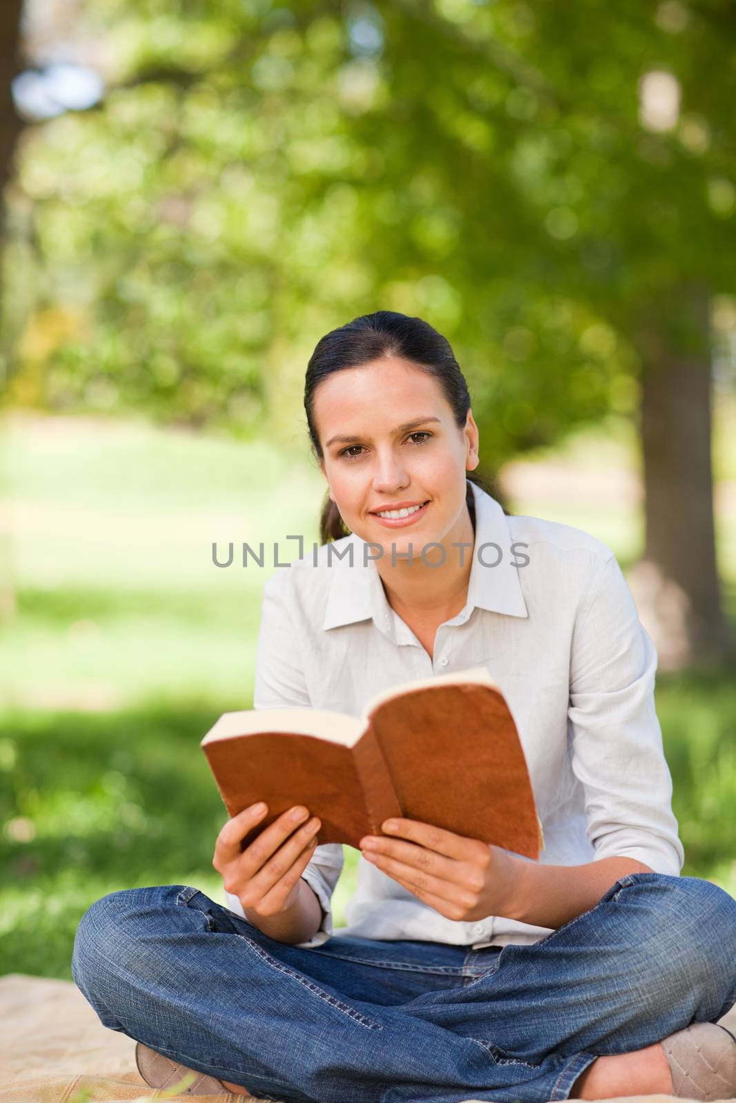 Woman reading in the park during the summer