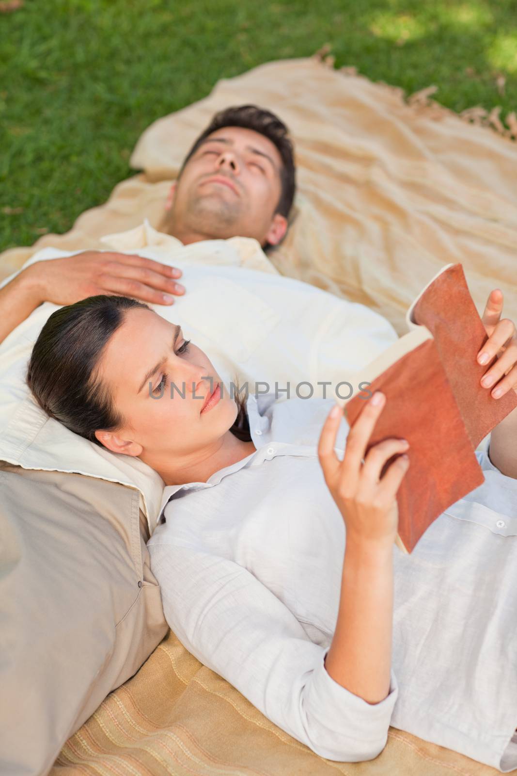 Couple reading in the park during the summer