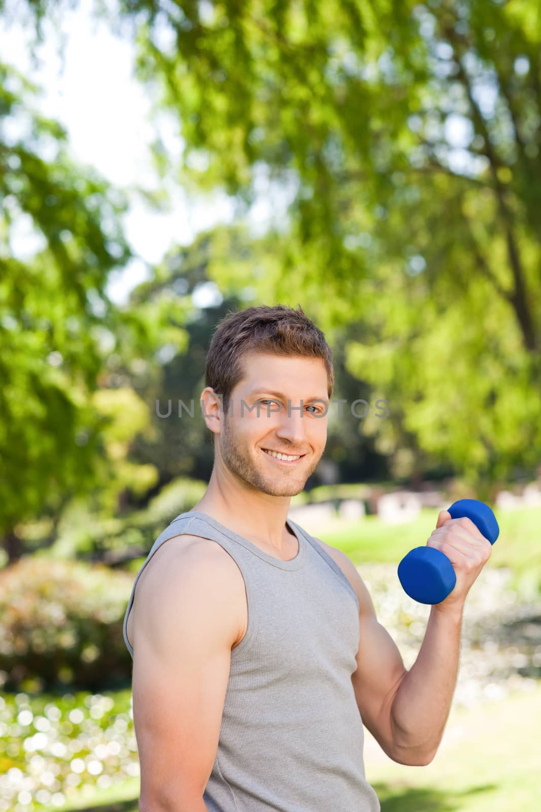 Young man doing his exercises in the park by Wavebreakmedia
