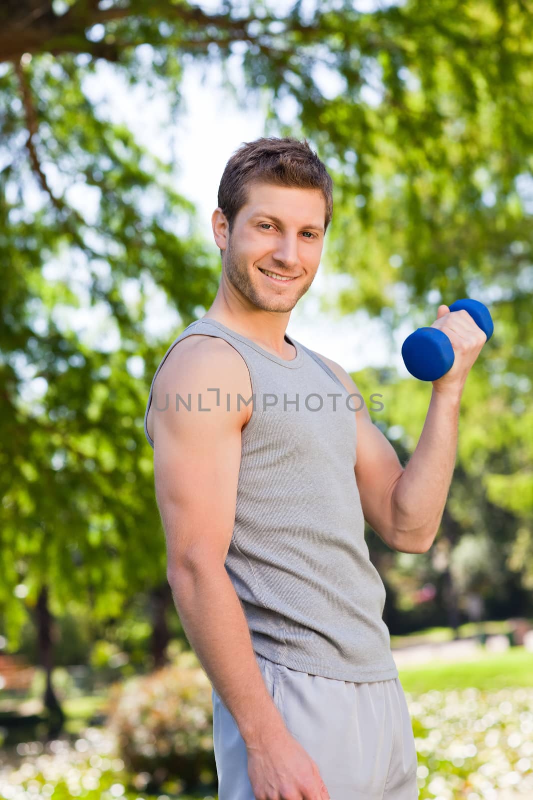Young man doing his exercises in the park by Wavebreakmedia