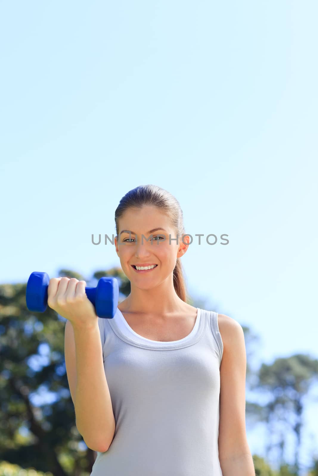 Young woman doing her exercises in the park by Wavebreakmedia
