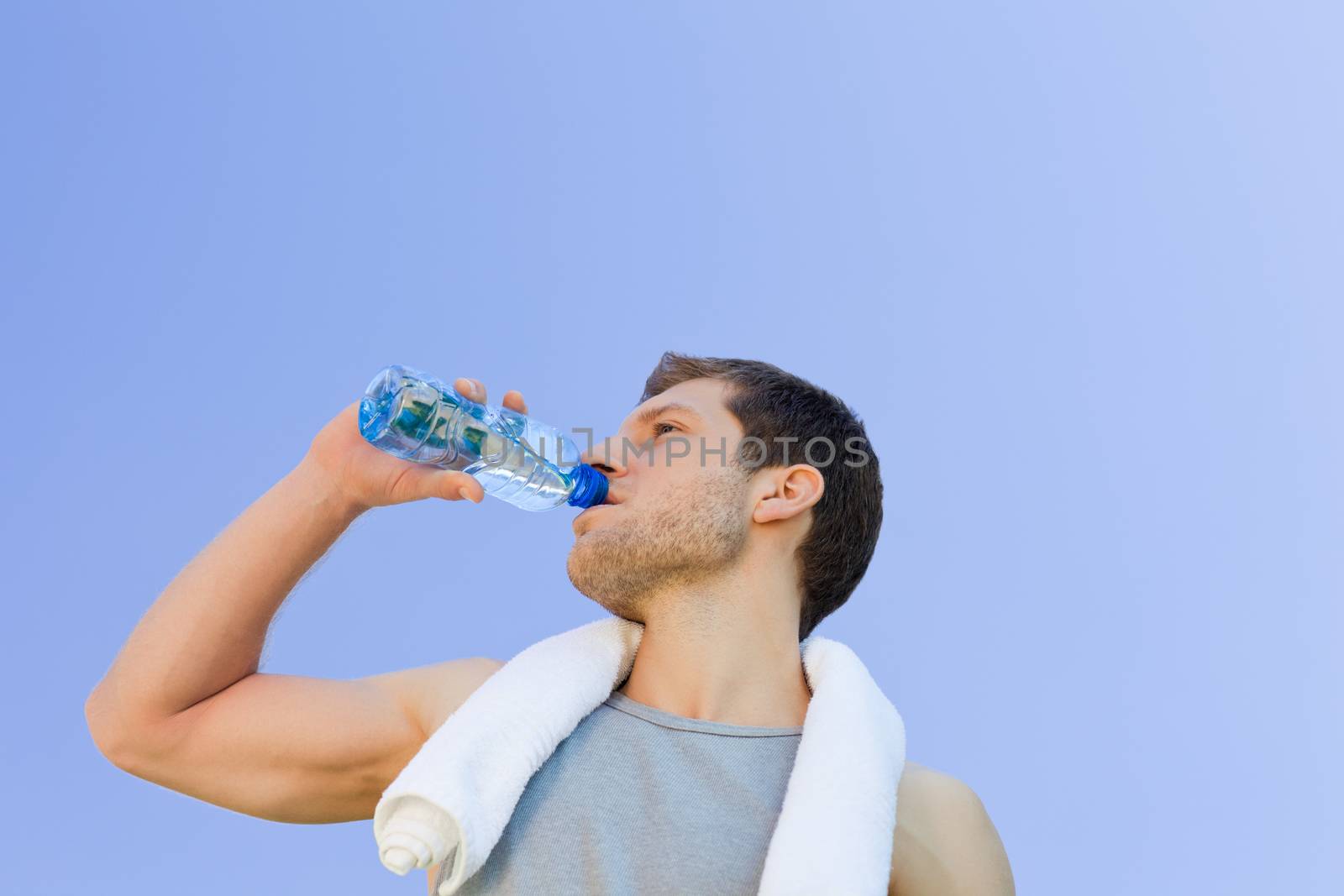 Man drinking water after the gym during the summer